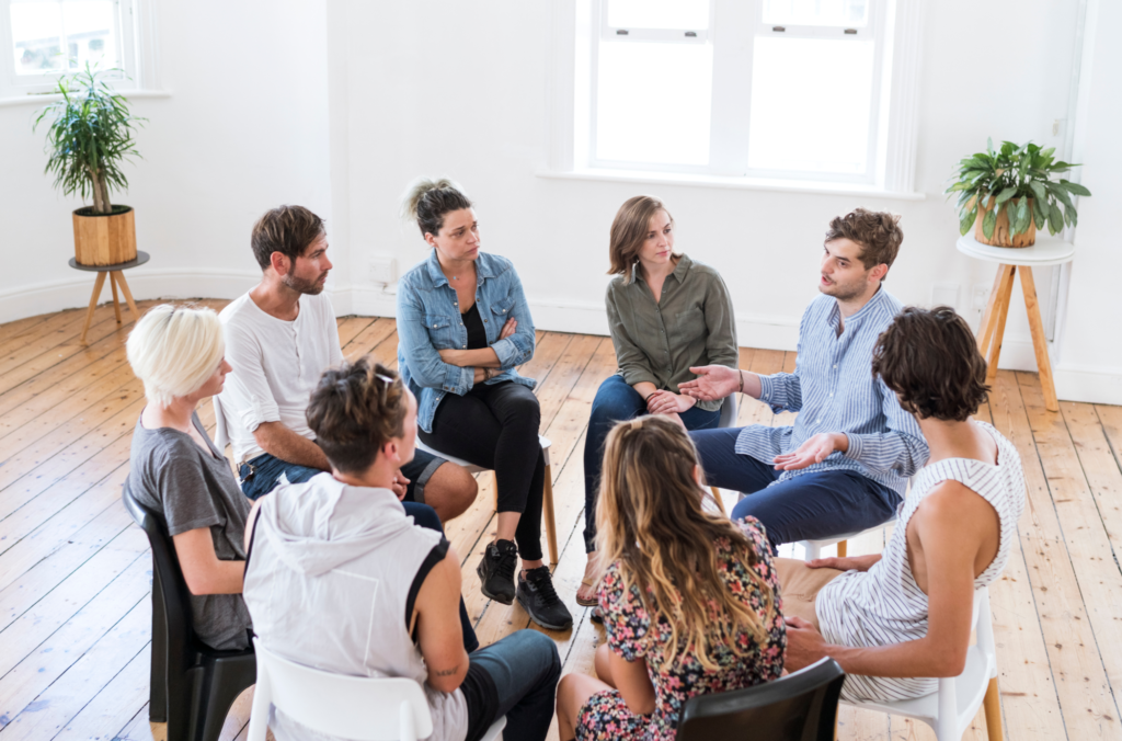 Adults participating in a therapist-led group therapy session